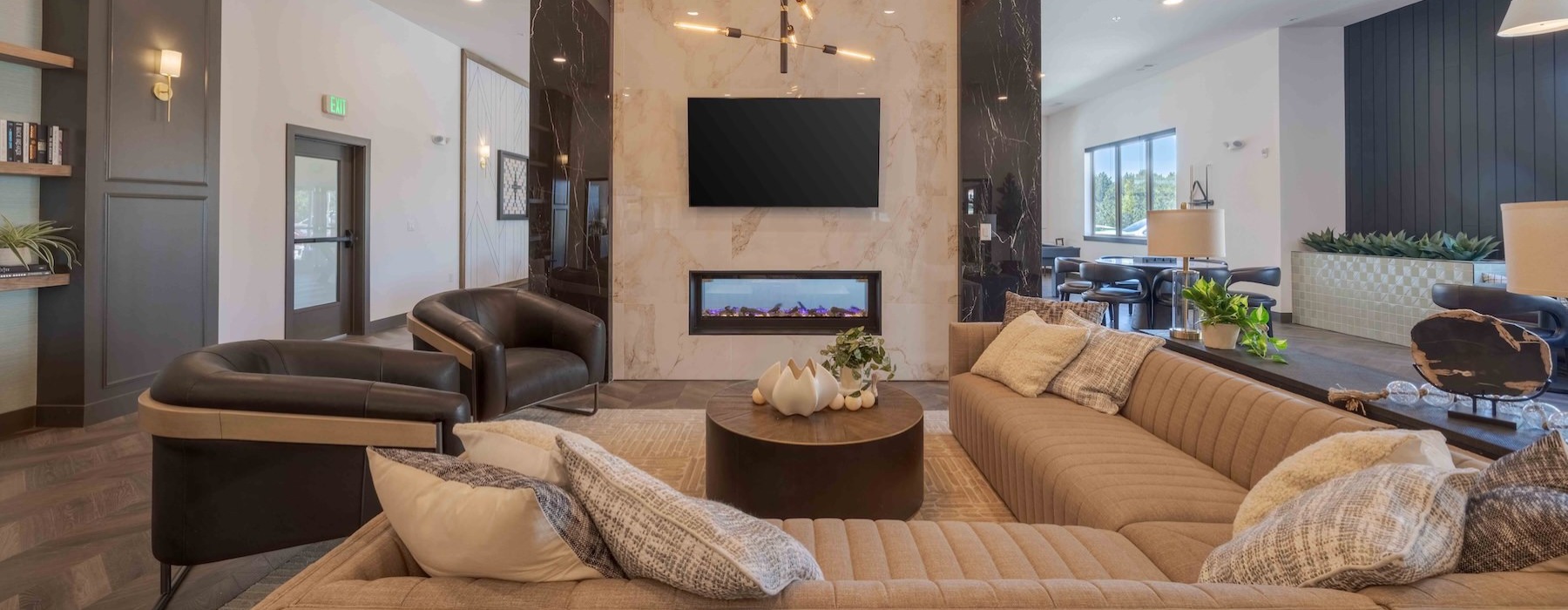 a club room with a large tv and couches