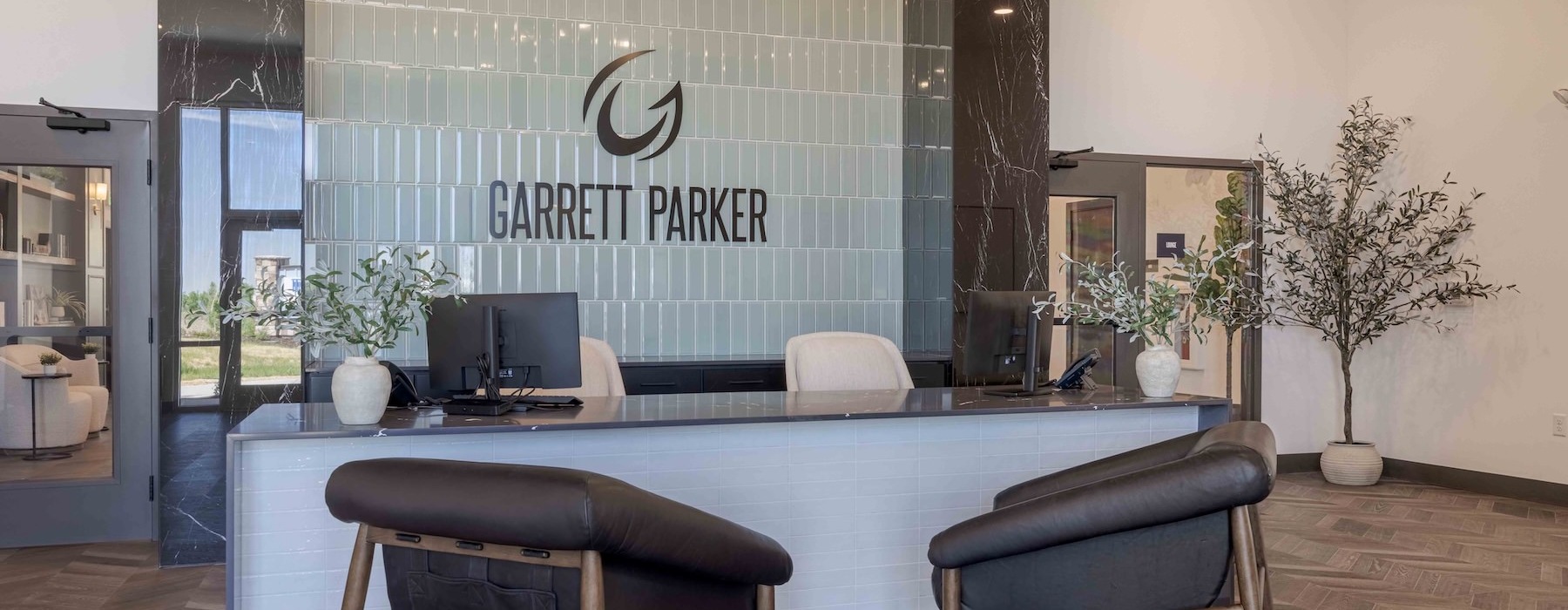 front desk area with a large sign and chairs