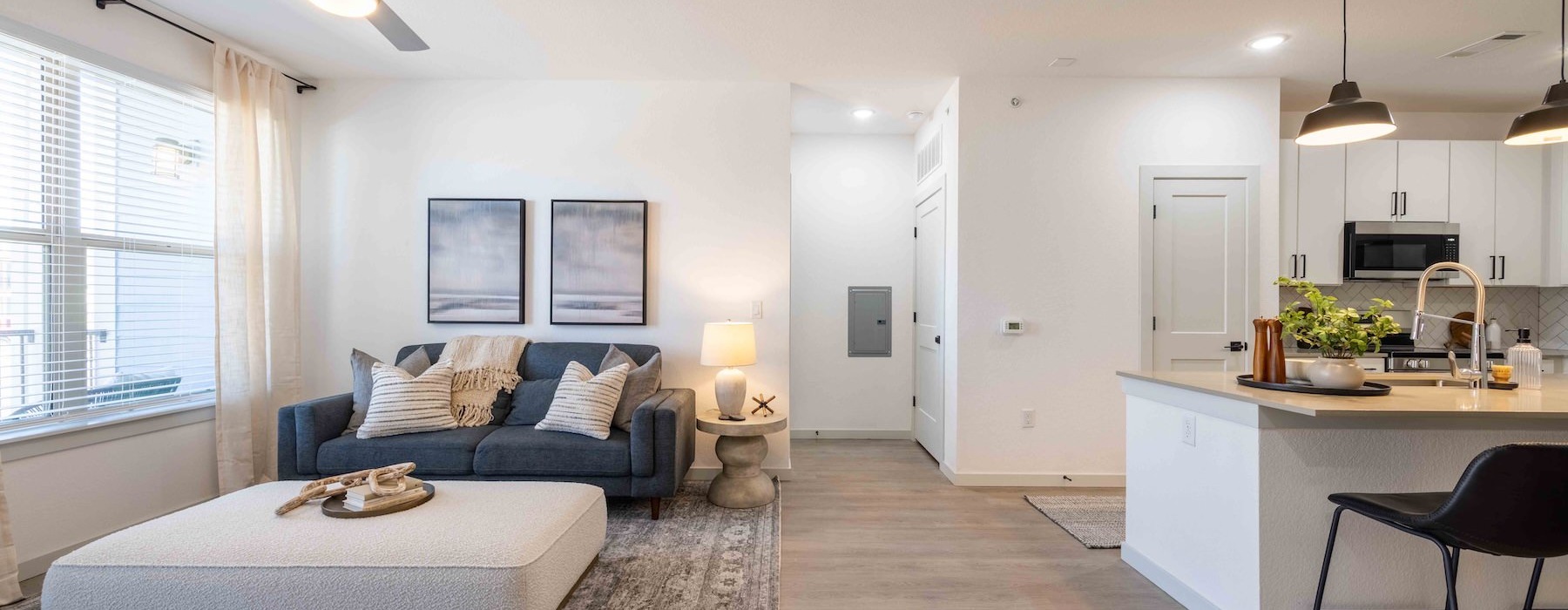 a large living room with a couch and a table